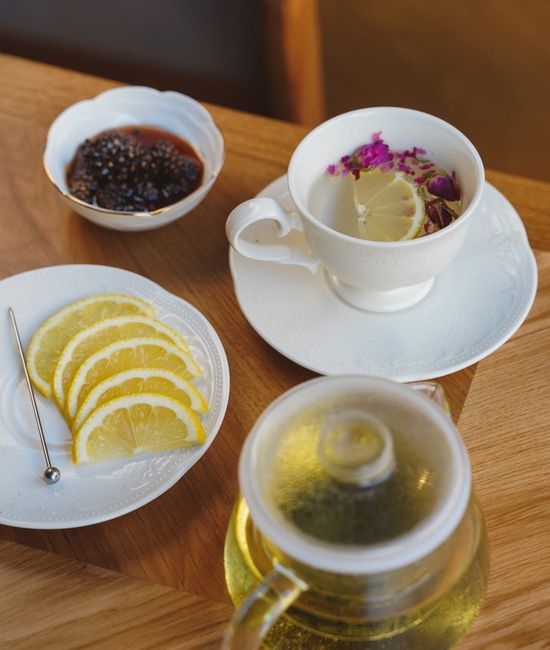 Ceramic cup with herbal infusion on wooden table